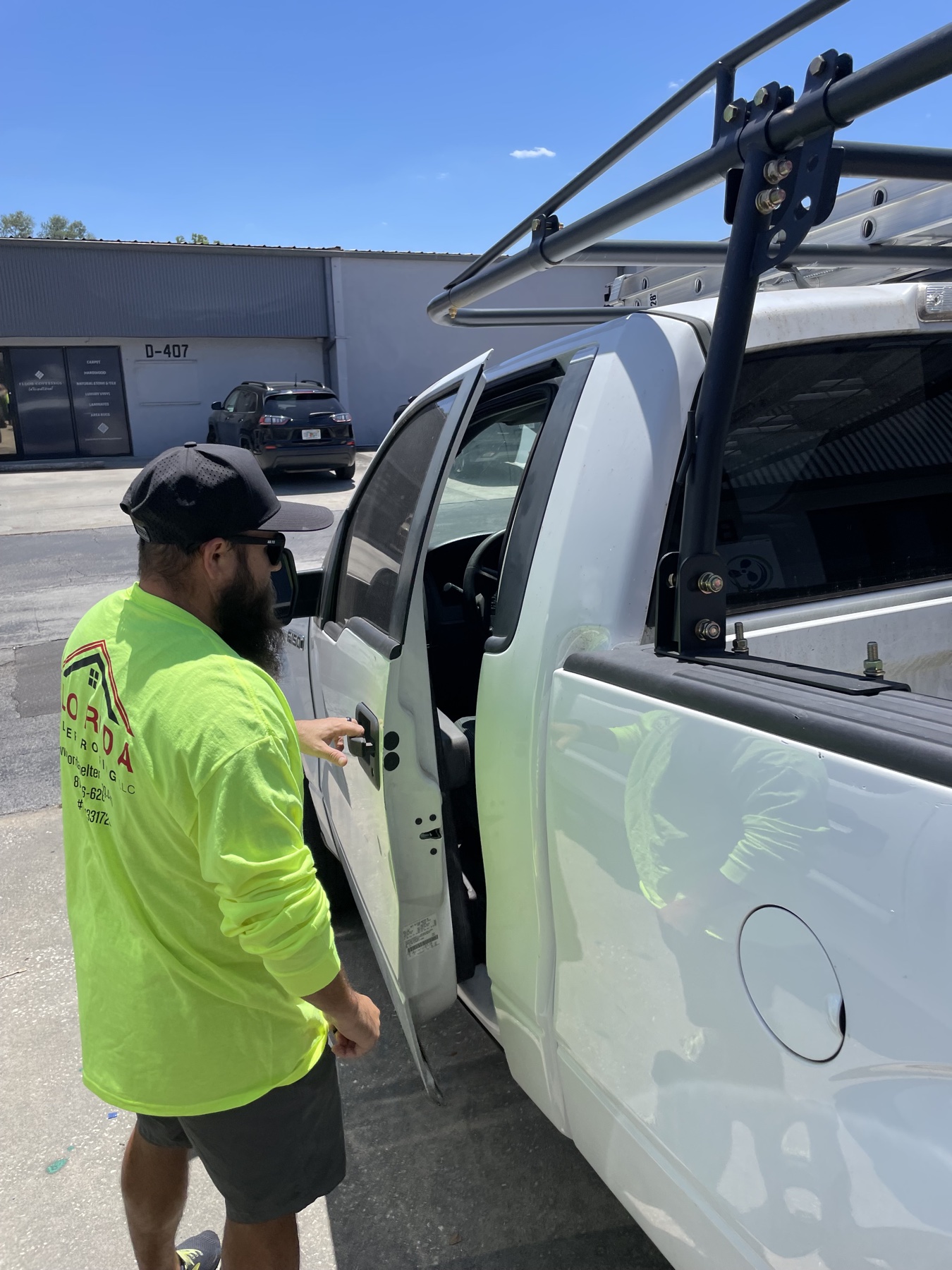 FSR crew member in branded shirt heading to the work truck with ladder rack